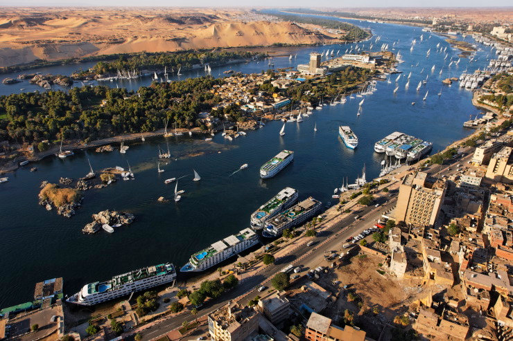 Why does the world come to Aswan?